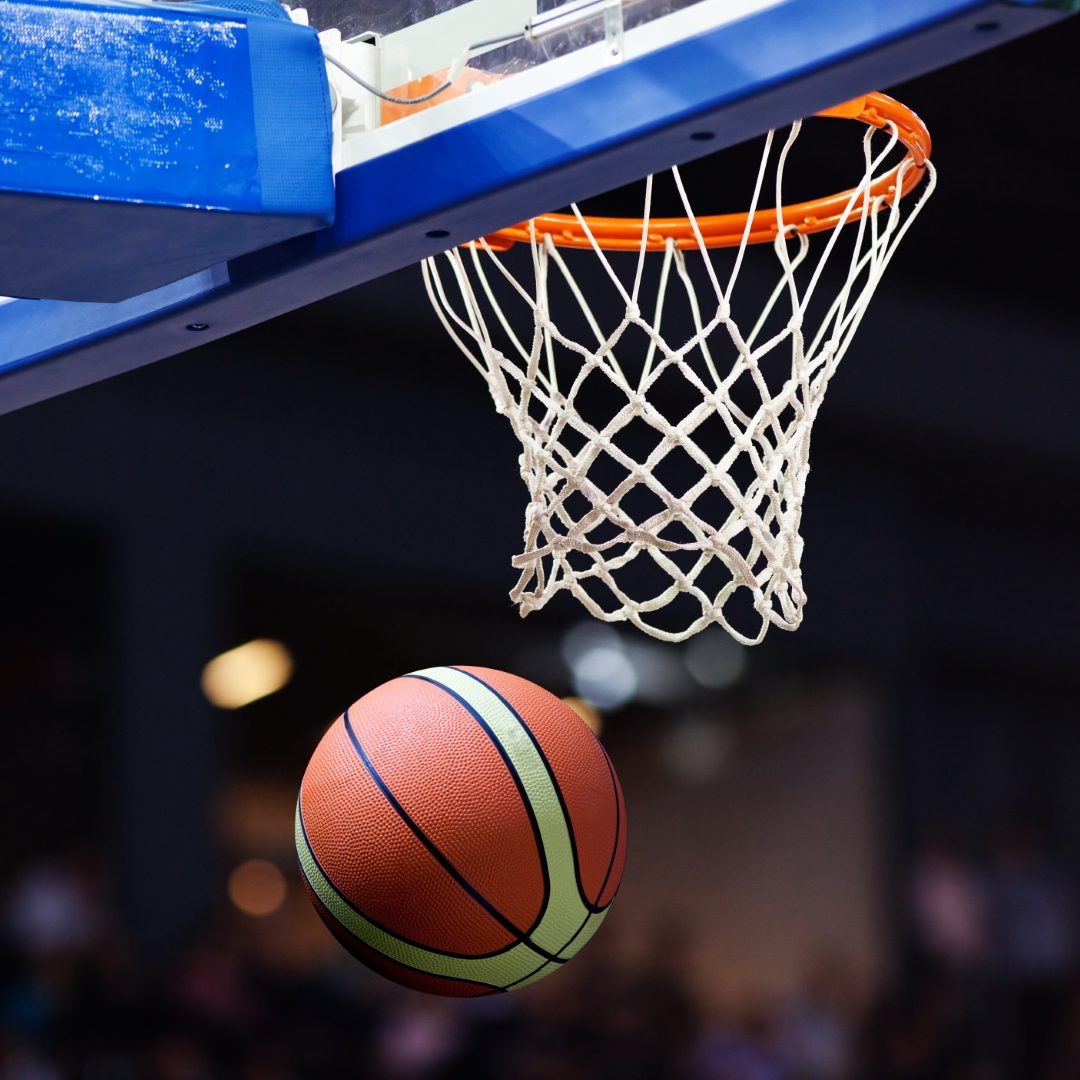 Basketball going through the hoop at a sports arena